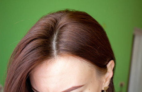 女人头上的头发特写。头发棕色的。
