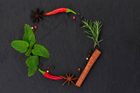 Colourful various herbs and spices on dark background. Top view 