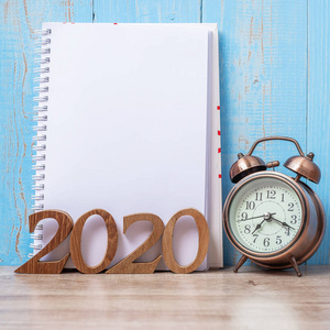 2020 Happy New Year  with blank notebook, retro alarm clock and 