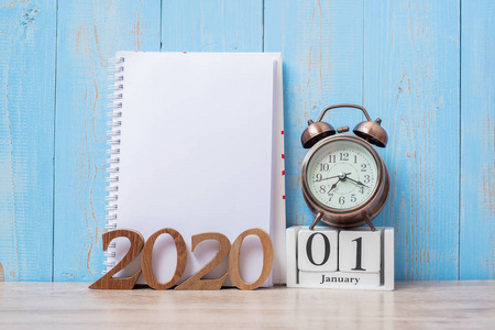 2020 Happy New Year  with blank notebook, retro alarm clock and 