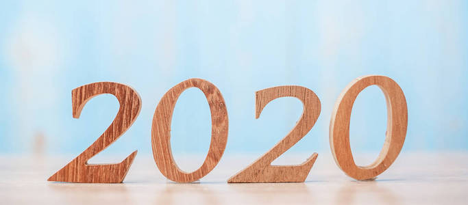 2020 wooden number on blue table background with copy space for 