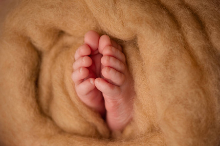 用布包着的婴儿腿。新生儿