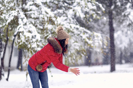  girl playing with snow on winter day.Happy holiday.