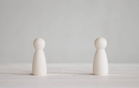 2 standing wooden dolls on the table 