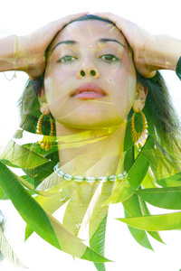 Double exposure portrait of a beautiful exotic woman with hands 