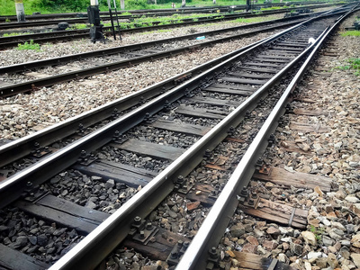 Crossing  railroad tracks   in a   city  train station 