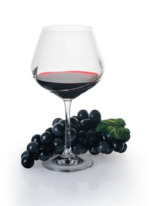 glass of red wine with grapes 