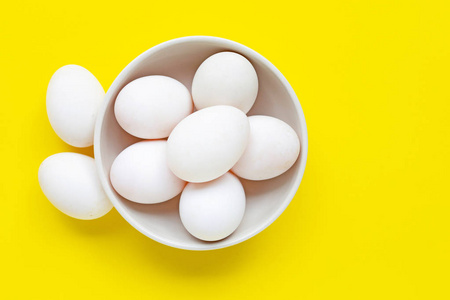 White eggs on yellow background. 