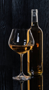 bottle and glass with white wine 