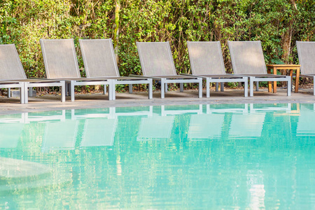 Empty chair around swimming pool in hotel resort