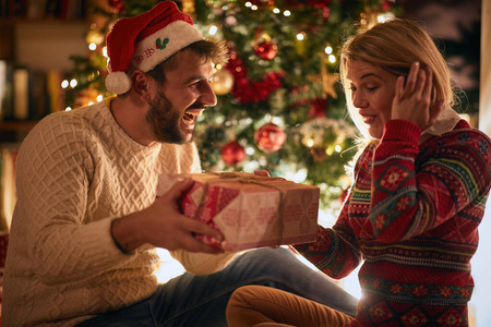 young couple celebrating Christmas and having fun 