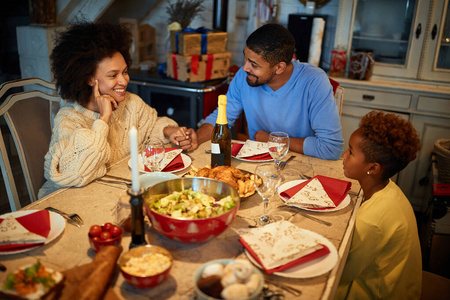 African family are having dinner at home. Celebration holiday wi