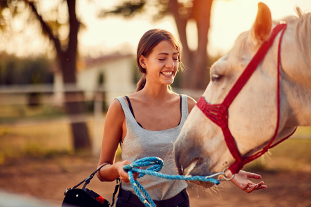  smiling girl ranchers palming horse