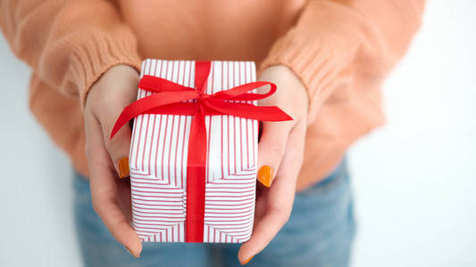 Closeup female hands holding gift box. 