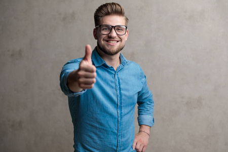 Modern casual man giving a thumbs up and smiling 