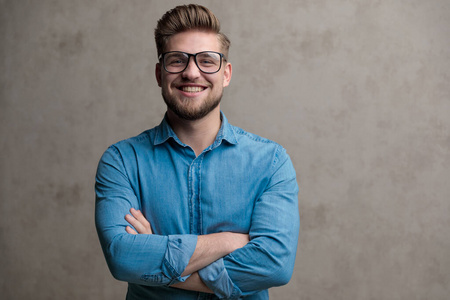 Confident casual smiling with his arms crossed at his chest 