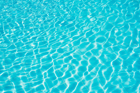 Background of water in blue swimming pool, water surface with a 