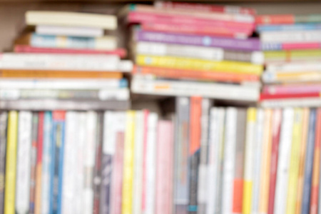 Blure background of a  books stacking on  shelf 