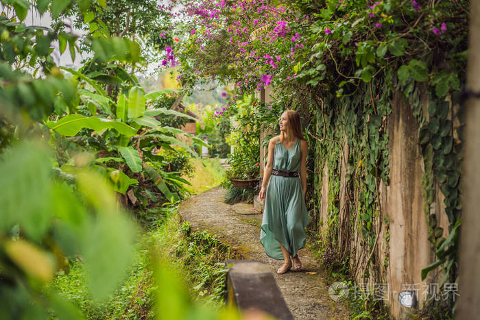 巴厘岛的年轻女游客沿着乌布的狭窄舒适街道散步。巴厘岛是一个受欢迎的旅游胜地。巴厘岛旅游概念