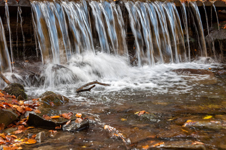 Colorful majestic waterfall in autumn forest 