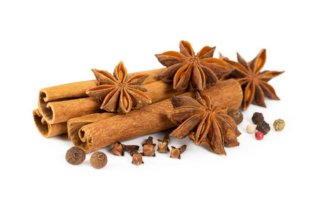 Cinnamon, star anise, cloves and mixture of peppers isolated on 