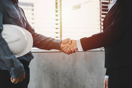 Asian Business people shaking hands and smiling their agreement 