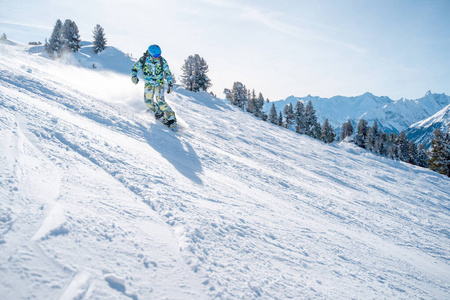 戴头盔的运动员在雪坡上滑雪的照片