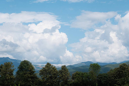 Green mountain and blue sky background 