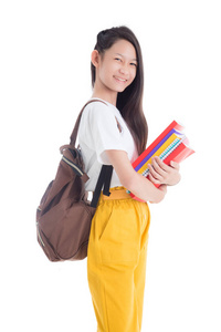 Beautiful asian teenage girl holding books and smiles 