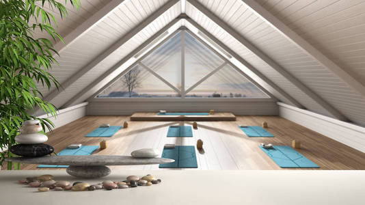 白色的桌子架上有鹅卵石平衡和3d字母,在空荡荡的瑜伽冥想室上写着"