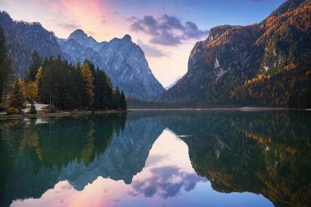 Dolomites mountains with reflection in Lago di Dobbiaca lake at 