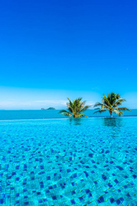 Beautiful luxury outdoor swimming pool in hotel resort with sea 