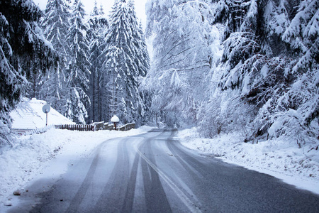 Empty road with snow banks on sides.