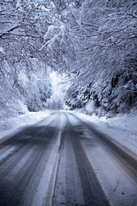 Empty road with snow banks on sides.