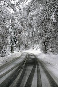 Empty road with snow banks on sides.