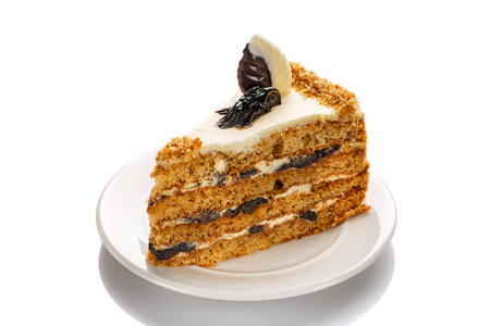 A piece of cake with honey and prunes, highlighted with a white 