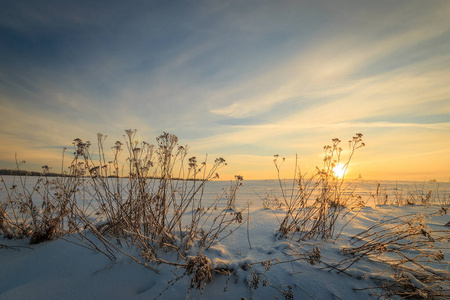  beautiful sunset with  covered grass at winter season