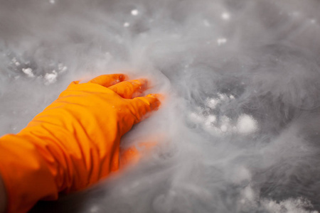 Thick white smoke on a background of black ceramic tiles. 