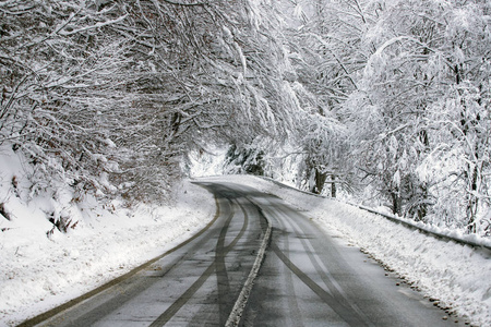 Empty road with snow banks on sides.