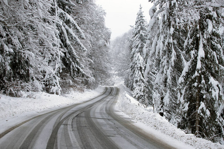 Empty road with snow banks on sides.