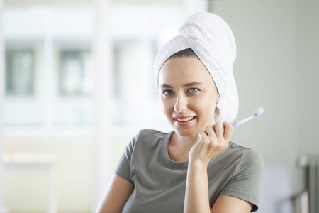 Portrait of a smiling cute woman holding toothbrush 