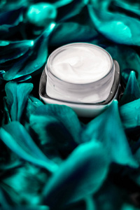 Luxury face cream moisturizer for facial skin on emerald flower 