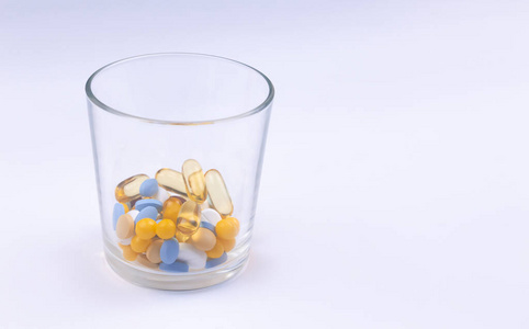 Dose of the colored pills in the glass of the package of pills. 