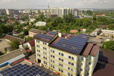 Aerial view of many solar panels mounted of industrial building 