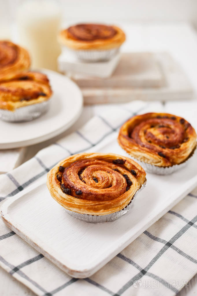 freshdanishpastrywithraisinsonwoodbackgroundtastysweet