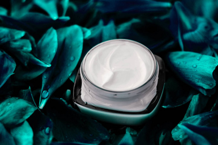 Luxury face cream moisturizer for facial skin on emerald flower 