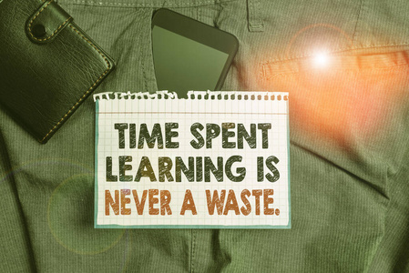 写笔记显示学习的时间绝不是浪费。商业照片展示教育无穷无尽的学习智能手机设备裤子前口袋与钱包。