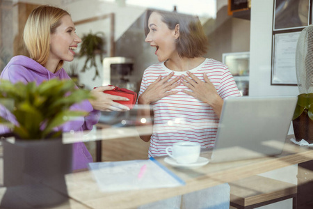 Emotional brunette woman looking at her friend