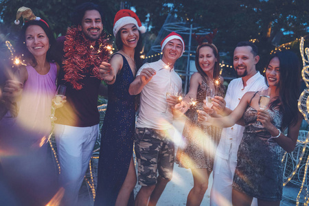 Group of happy people of mixed race friends celebrate Christmas 