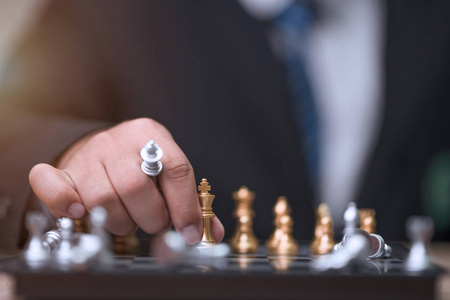 Business man holding golden king chess 